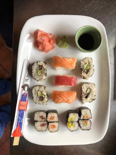 a plate with sushi and vegetables on a table at Les Park Vřesovice in Vřesovice