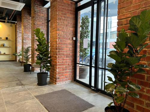 a room with a brick wall with potted plants at Kingston Hotel 7 - Johor Bharu in Johor Bahru