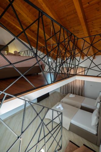 an attic room with two beds and a couch at Atlantis Hotel & Apartments in Ksamil