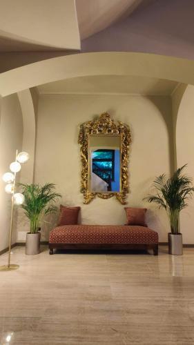 a couch in a room with a mirror on the wall at Villa Giordana in Casalborgone