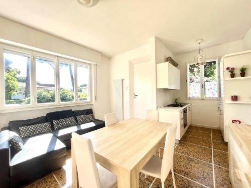 a living room with a wooden table and a couch at Pineta Apartament in Tirrenia