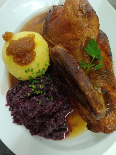 a plate of food with meat and other foods at Landgasthof zum Rappen in Creglingen