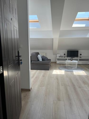 an open door to a living room with a couch at Apartment J.J in Požarevac