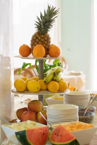a three tiered display of fruit on a table at Hotel Bristol in Sottomarina