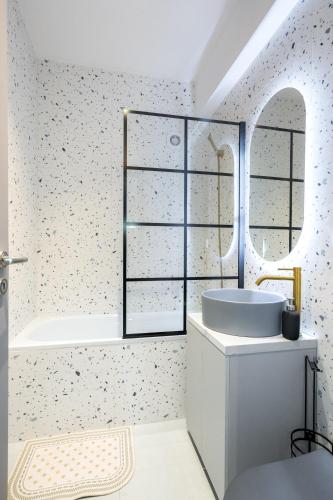 a white bathroom with a tub and a sink at Dreamy City Center in Bucharest