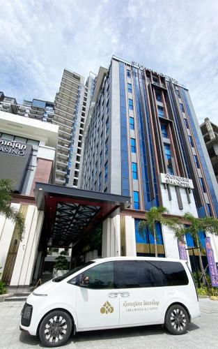 a white van parked in front of a building at SIHA Hotel & Casino in Sihanoukville