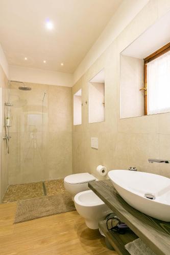 a bathroom with a sink and a toilet and a shower at Residence Via Duomo in Verona