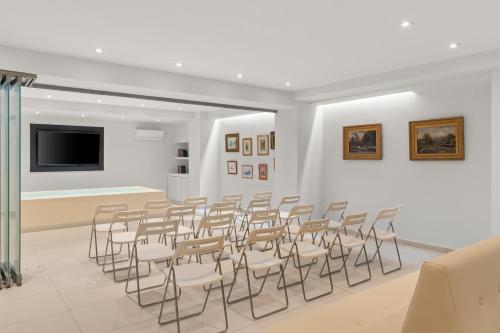 a room with a bunch of chairs and a flat screen tv at Gallery Central Piraeus Port in Piraeus