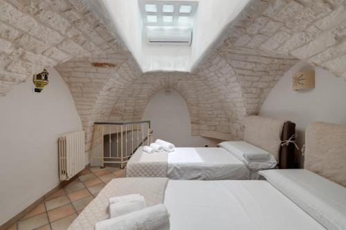 A bed or beds in a room at Dimora Gli Arcangeli
