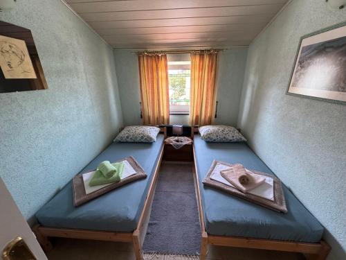 a room with two beds in it with a window at Apartments Finida in Poreč