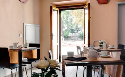 a dining room with tables and chairs and a window at Hotel Il Cavallo in Barberino di Mugello