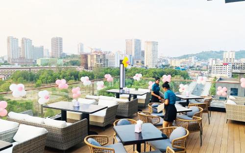 a balcony of a restaurant with tables and chairs at SIHA Hotel & Casino in Sihanoukville