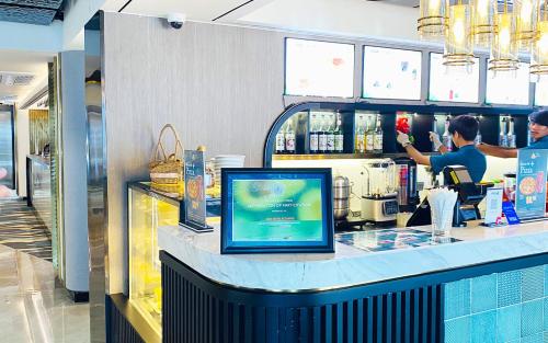 a woman standing at a counter in a store at SIHA Hotel & Casino in Sihanoukville