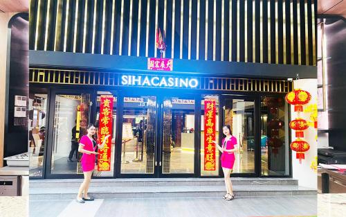a woman standing in front of a shasoya store at SIHA Hotel & Casino in Sihanoukville