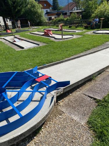 a blue boat sitting on a sidewalk in a park at Edelsteinhotel Guniwirt in Krakaudorf
