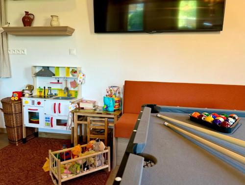 a living room with a couch and a table with baseball bats at Apartmány Roháče in Zuberec