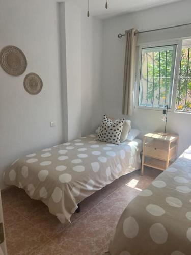 a bedroom with a bed and a window at Casa Verano in Alicante