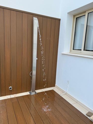 a room with a door with water coming out of it at Paez Villa in Protaras