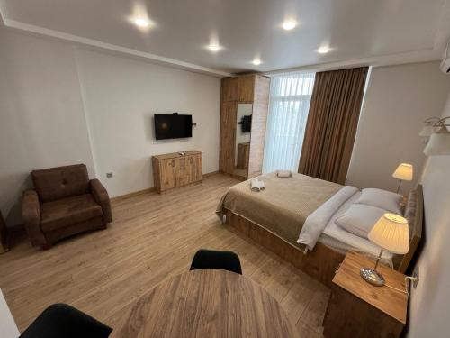 Ένα ή περισσότερα κρεβάτια σε δωμάτιο στο Aparthotel Holiday Lux Batumi