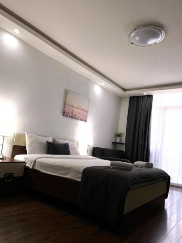 Ένα ή περισσότερα κρεβάτια σε δωμάτιο στο Aparthotel Holiday Lux Batumi