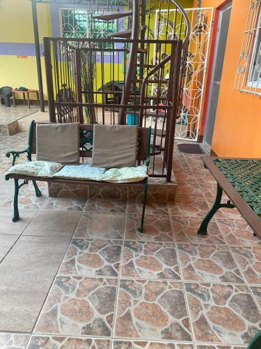 a bench sitting on a tile floor in a room at Villa 301 B&B in Baclayon