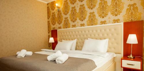 Ένα ή περισσότερα κρεβάτια σε δωμάτιο στο Aparthotel Holiday Lux Batumi