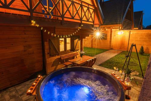 a large jacuzzi tub in the backyard of a house at Domki Gorczański Zakątek - Jacuzzi in Nowy Targ
