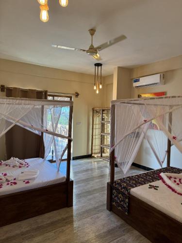 a bedroom with two bunk beds in a room at Peace And Color Limited Guest House in Nungwi