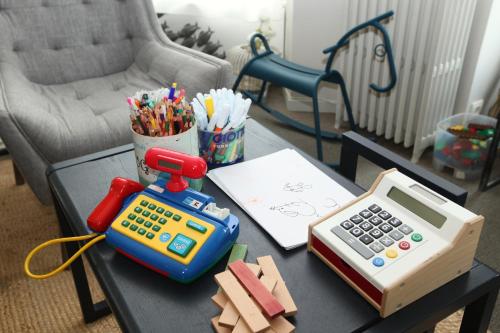 a table with a calculator and a calculator at Cit'Hotel Les Alizes in Dinard