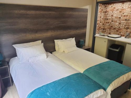 two beds sitting next to each other in a room at The Crooked Forest in Pretoria