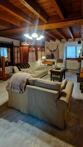 a large living room with a couch and a table at Ço desde Viandol in Bossost