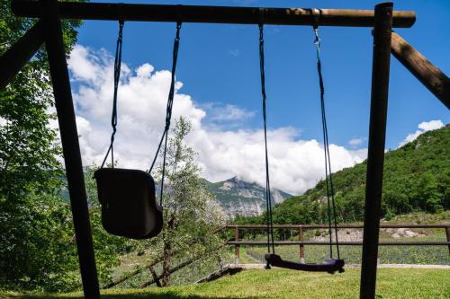 a swing with a view of a mountain at Maso Salim Relax Apartments in Drena