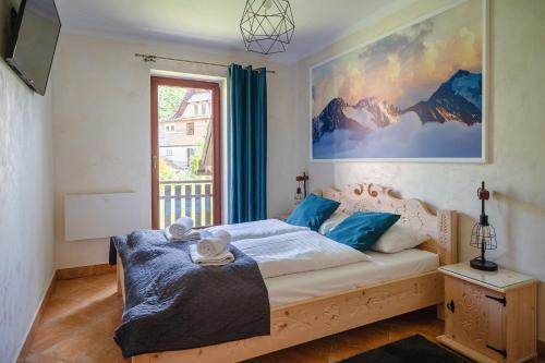 a bedroom with a bed and a window at Apartament Mountain View Kościelisko 42 in Kościelisko
