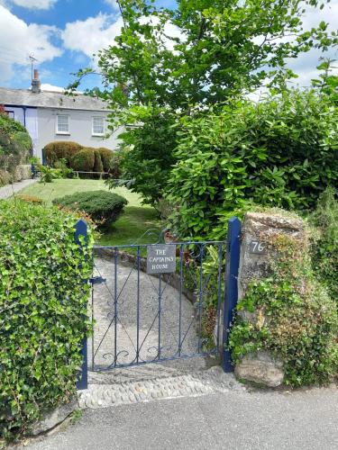a blue gate in front of a house at The Captain's House Charlestown St Austell in Charlestown
