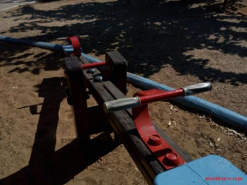 a cart with red and blue poles on the ground at Porto Skala Village Hotel in Skala Kefalonias