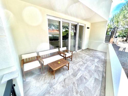 a balcony with a bench and a table at Delux 4 Stars Apartment Ariadne - 1 Min from Beach in Soline