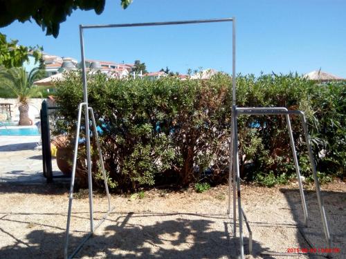 a swing set in a yard with a mirror at Porto Skala Village Hotel in Skala Kefalonias