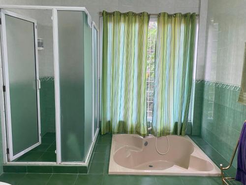 a bathroom with a bath tub and a shower at Villa 301 B&B in Baclayon