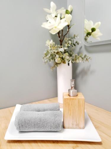 - une table avec des serviettes et un vase avec des fleurs dans l'établissement Bhangah - Verdure et Tranquillité, à Metz