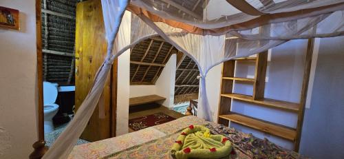 a bedroom with a bunk bed and a staircase at Salama & Mbuyuni Bungalows in Matemwe