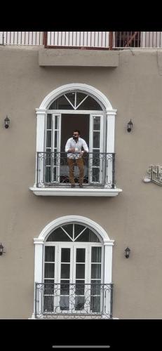a man sitting in a window of a building at Hari Leela fort view palace in Chittaurgarh
