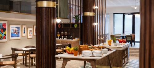 a restaurant with a table with plates of food at Radisson Hotel Cape Town Foreshore in Cape Town
