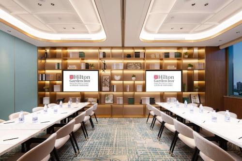 a conference room with long tables and chairs at Hilton Garden Inn Beijing West Railway Station in Beijing