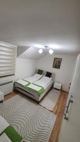 a bedroom with a bed and a rug at Central View Apartment 2 Sarajevo in Sarajevo