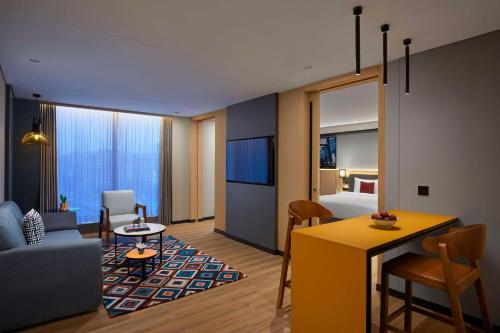 a hotel suite with a living room and a bedroom at Hyatt Centric Hebbal Bengaluru in Bengaluru