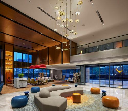 a large living room with a couch and chairs at Hyatt Centric Hebbal Bengaluru in Bengaluru
