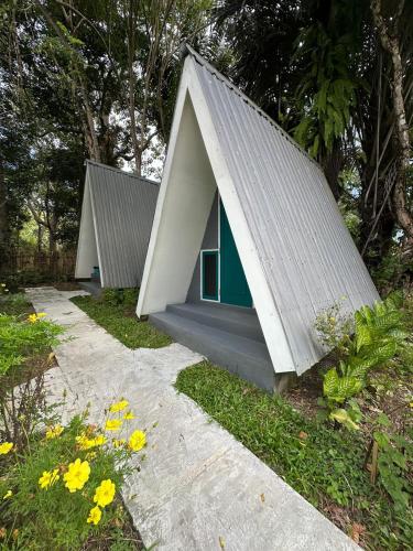 a group of three small houses with pitched roofs at D'flora Bungalow & Glamping in Noca