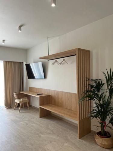 a living room with a desk and a tv at Liberte Maisonettes in Parga