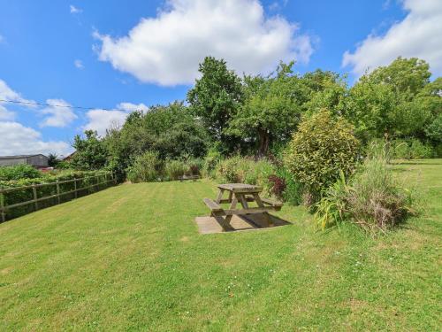 a picnic table in the middle of a field at The Hay Barn in Chester