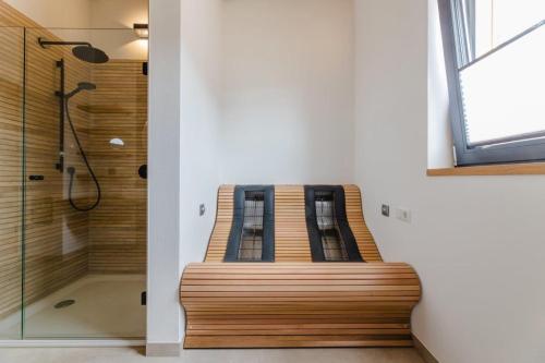 a bench in a bathroom with a shower at Birkenhof - Ferienhof, Landcafe und Rösterei in Schmallenberg